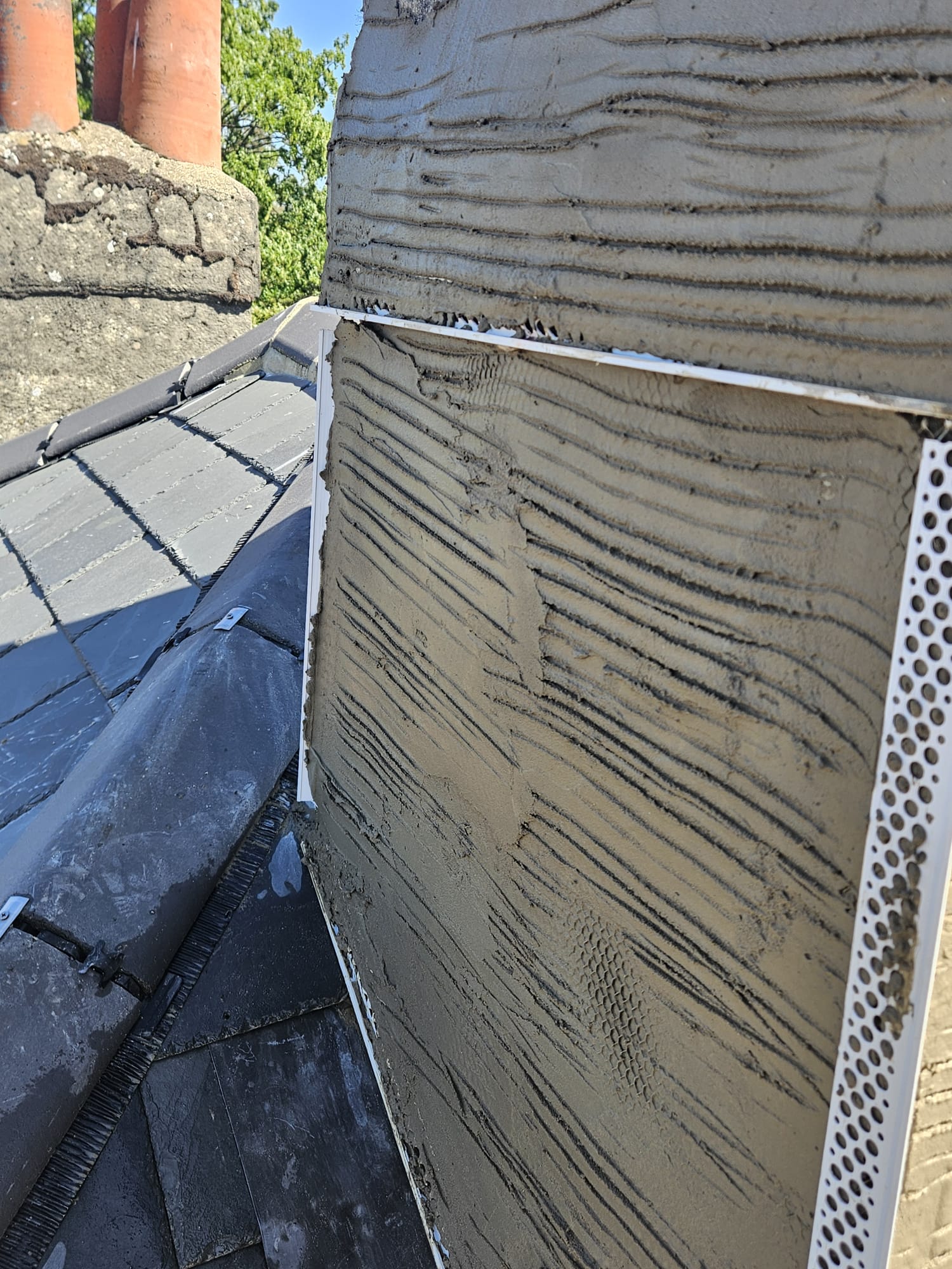 Close up of fresh render and corner beads on a Surrey chimney stack repair