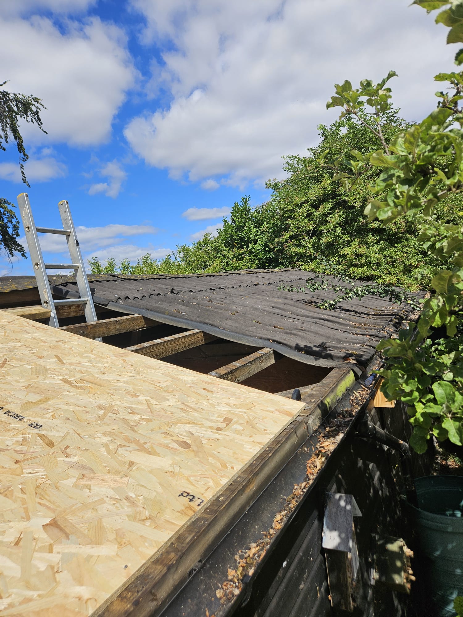 Old flat roof covering stripped and new timber decking laid in Surrey