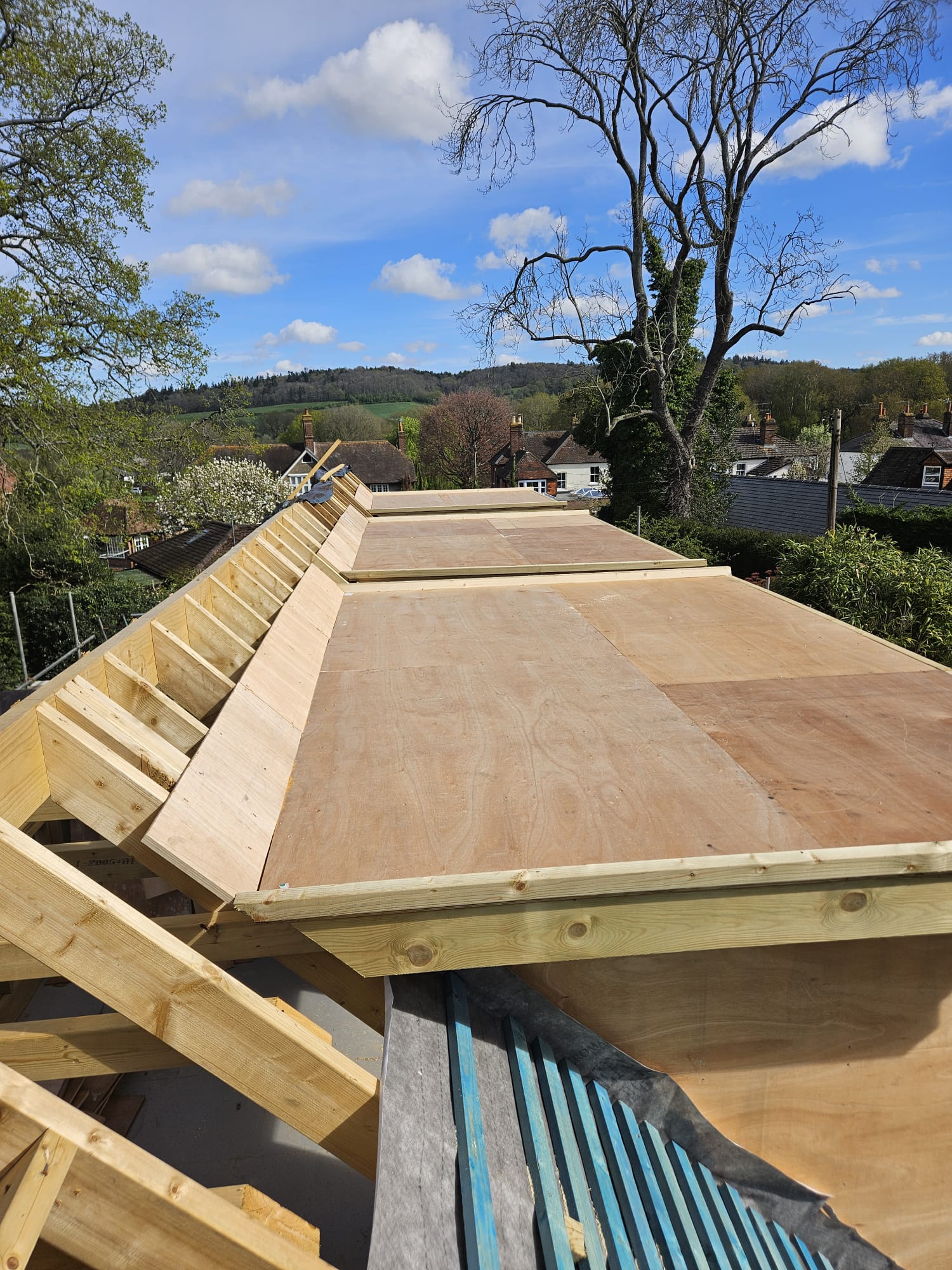 New roof structure and decking built over a Surrey property with village views