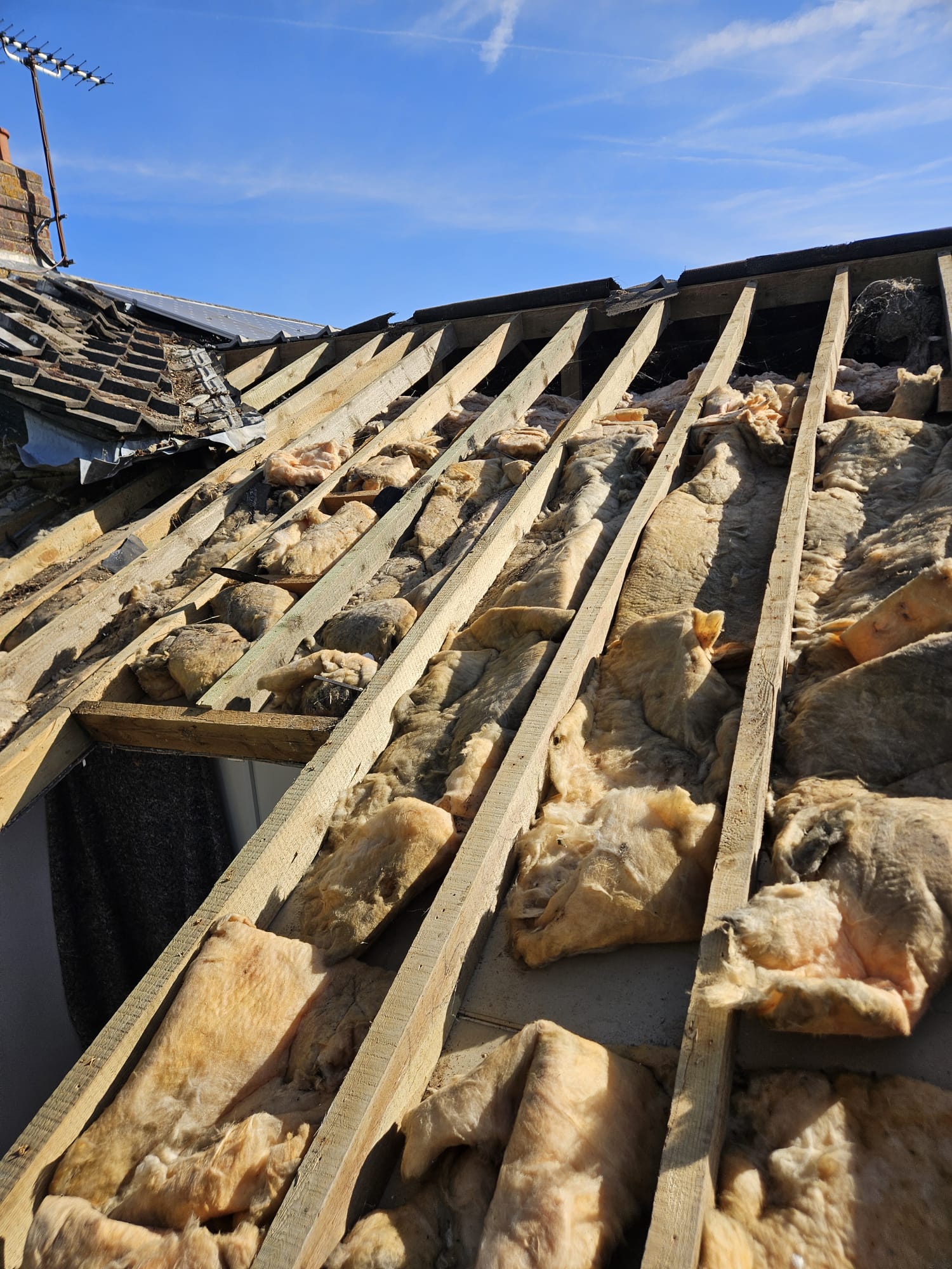 Roof stripped back to rafters before a full re-roof in Surrey