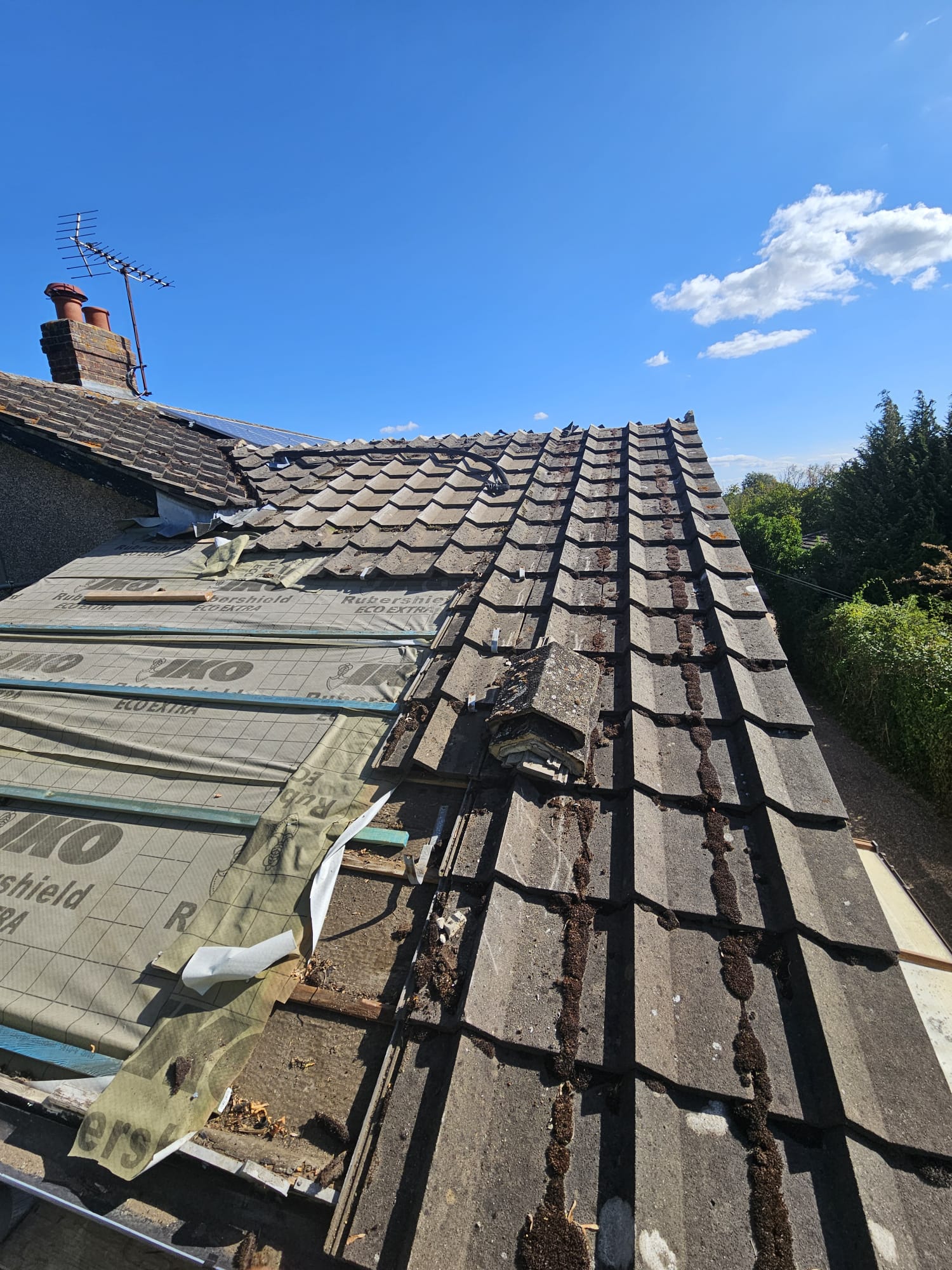 Tiles stripped and re-laid over new underlay during tiling repairs in Surrey