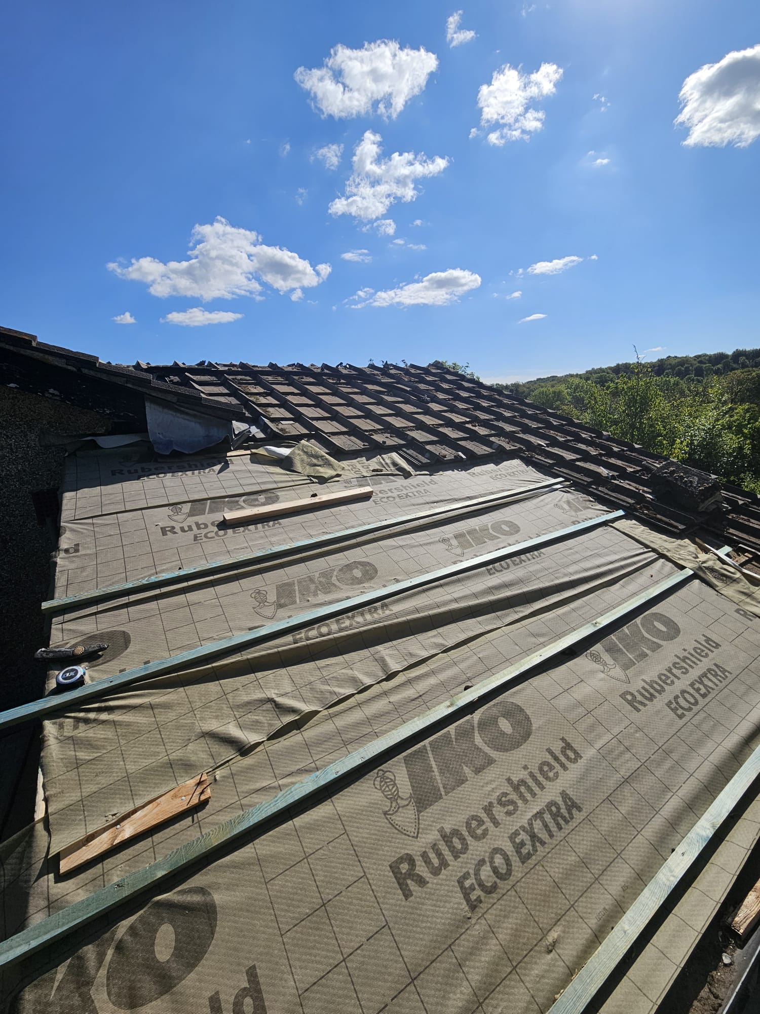 Old tiles stripped back and new roofing underlay fitted during a Surrey re-roof