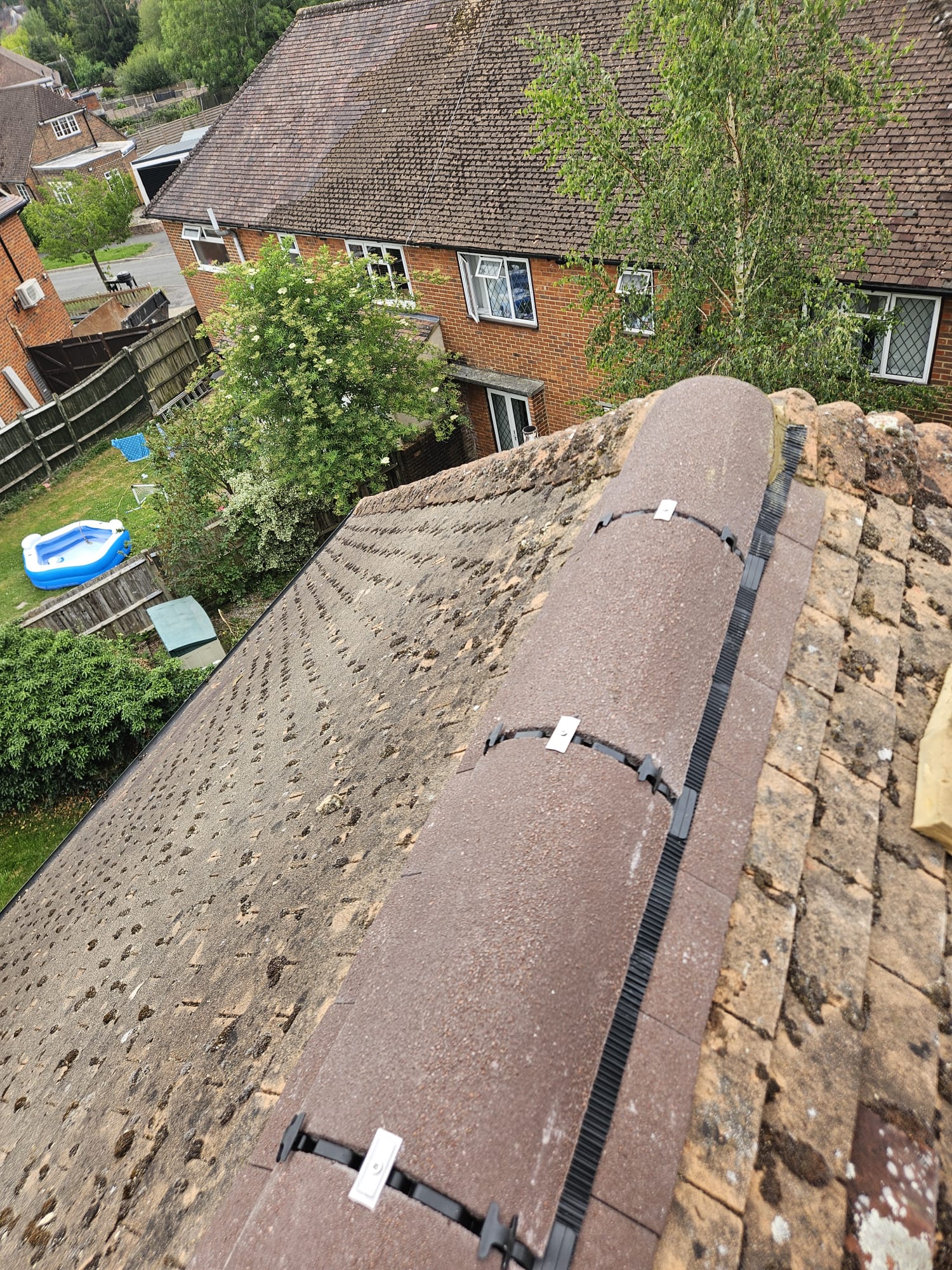 Ridge tiles re-bedded with a dry fix ridge system after roof repair in Surrey